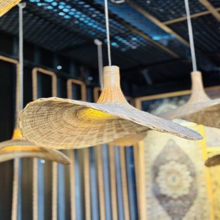 Inspired by the warmth of nature and the intricacy of traditional weaving, the Golden Nest Bamboo Pendant Light brings timeless beauty to modern interiors. Its round, globe-shaped silhouette is handwoven from natural bamboo in a crisscross lattice pattern, diffusing a soft, golden glow that transforms any space into a cozy haven. Perfect for ambient lighting in dining areas, reading nooks, cafes, or entryways, this artisan-made fixture seamlessly blends rustic charm with minimal elegance. Lightweight yet durable, it's a sustainable lighting solution that reflects conscious craftsmanship.