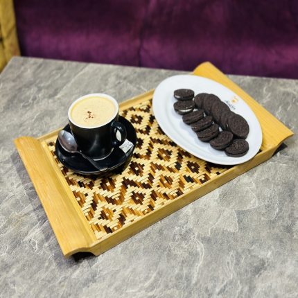 Bring natural elegance to your table with our Handcrafted Bamboo Woven Serving Tray, beautifully made by skilled artisans. Featuring an eye-catching geometric tribal pattern, this tray is crafted from eco-friendly bamboo and rattan, making it a sustainable yet stylish choice for your home. Whether you're serving tea, snacks, or simply using it as a decorative piece, this tray adds a touch of rustic charm to any setting. The sturdy wooden frame and finely woven center combine beauty with durability, perfect for everyday use or special occasions.